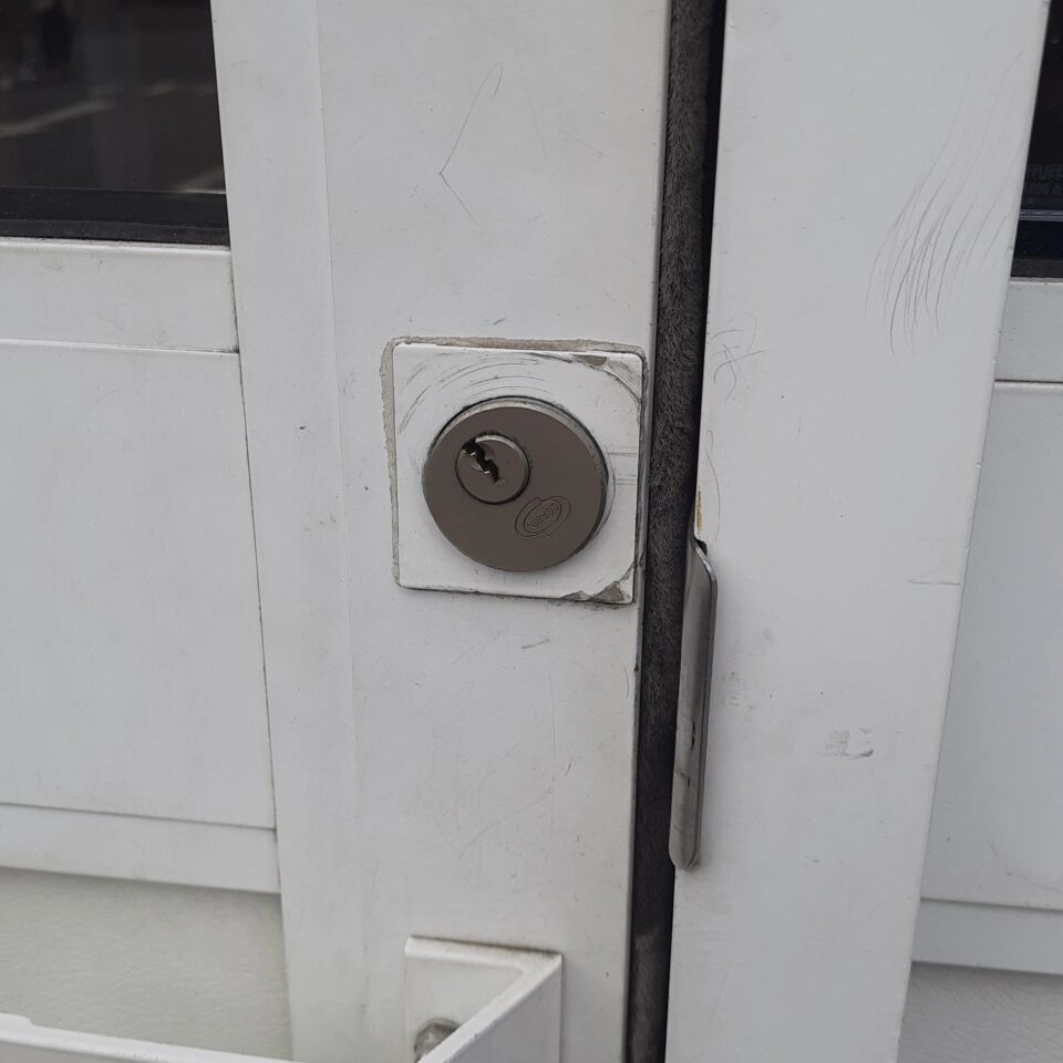 Commercial door cylinder repositioned and secured in Ashford