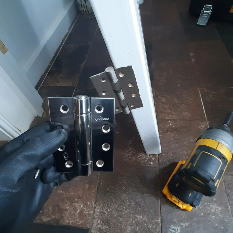 Fire-rated sprung hinges installed on a cloakroom door in Dorking